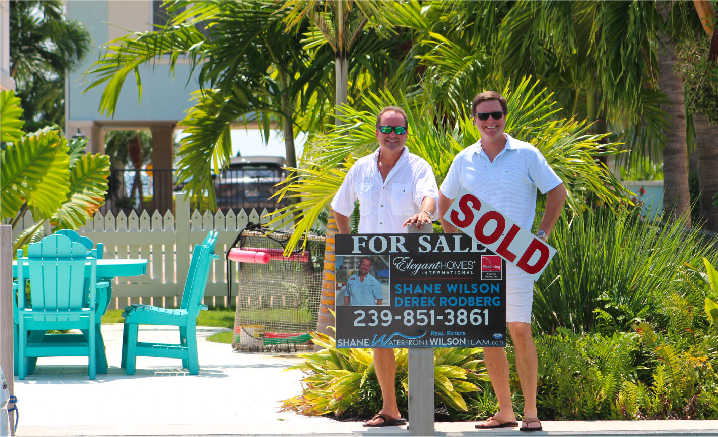 shane-derek Shane WIlson and Derek Rodberg with sold property sign in the Florida Keys