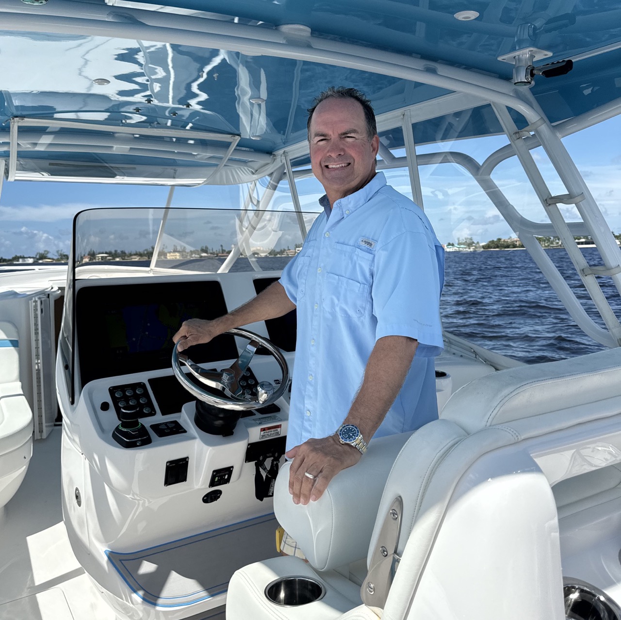 Shane Waterfront Wilson, a Florida Keys Realtor driving his center console in the Florida Keys.